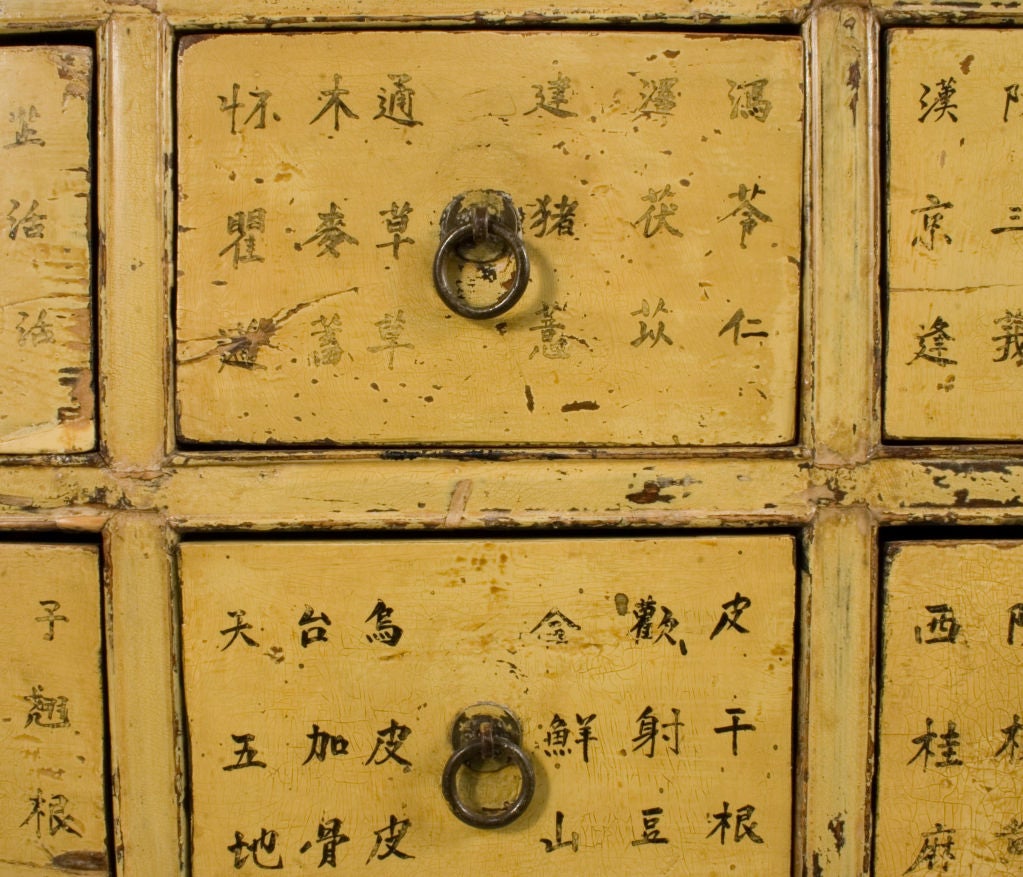 Chinese Medicine Cabinet in a worn yellow patina.