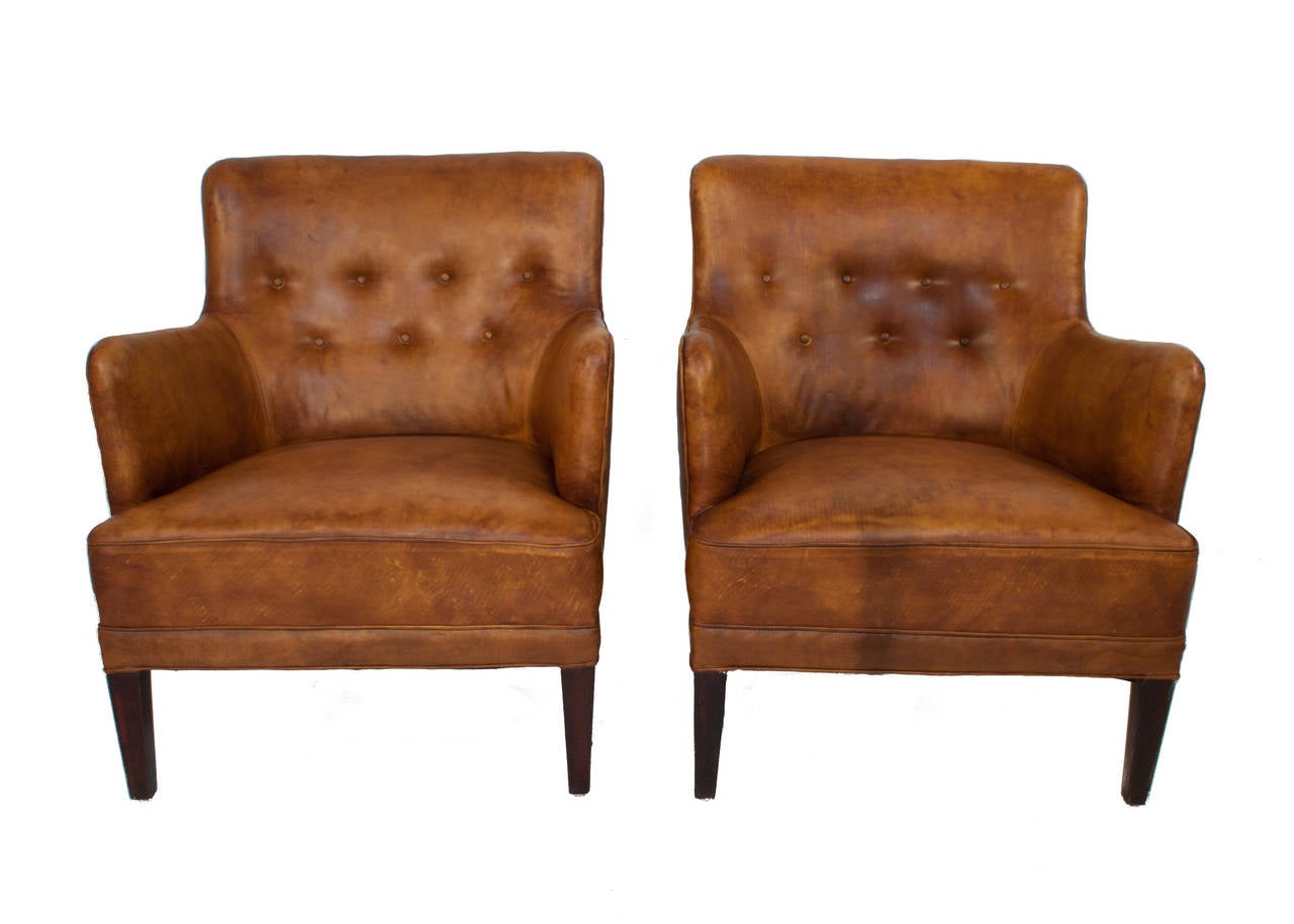 Pair of leather and mahogany lounge chairs by Frits Henningsen.
