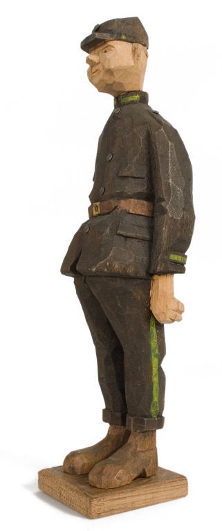 Carved and painted wooden figure of a soldier.