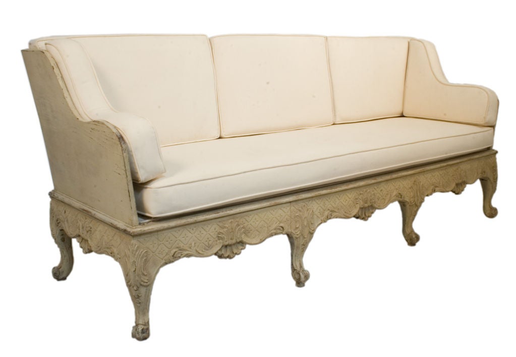 Rococo Sofa in a worn pale yellow patina.
