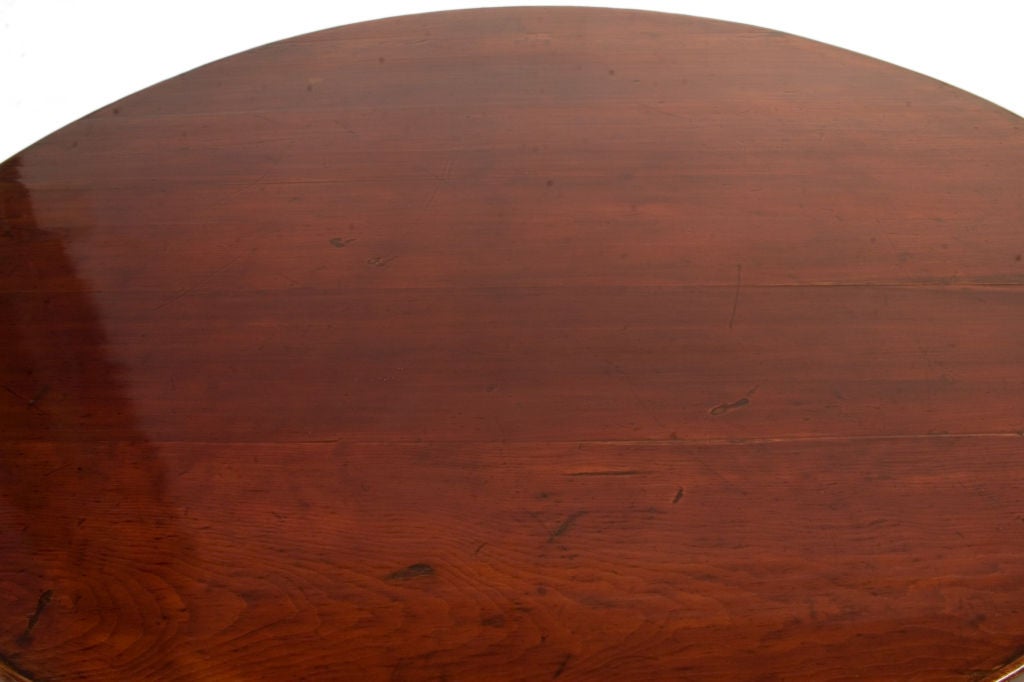 Round lacquered Chinese Hubei Coffee Table in a worn dark red patina.