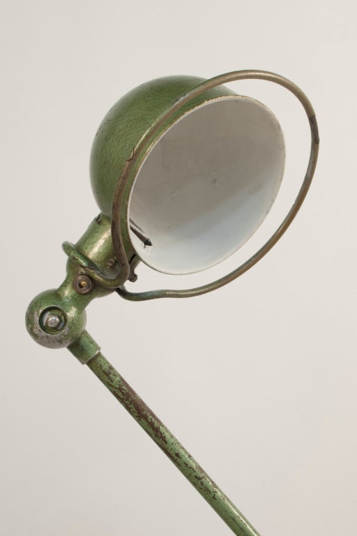 Floor Lamp by Jean Louis Domecq in a worn green patina and with the original brake rotor as a base.