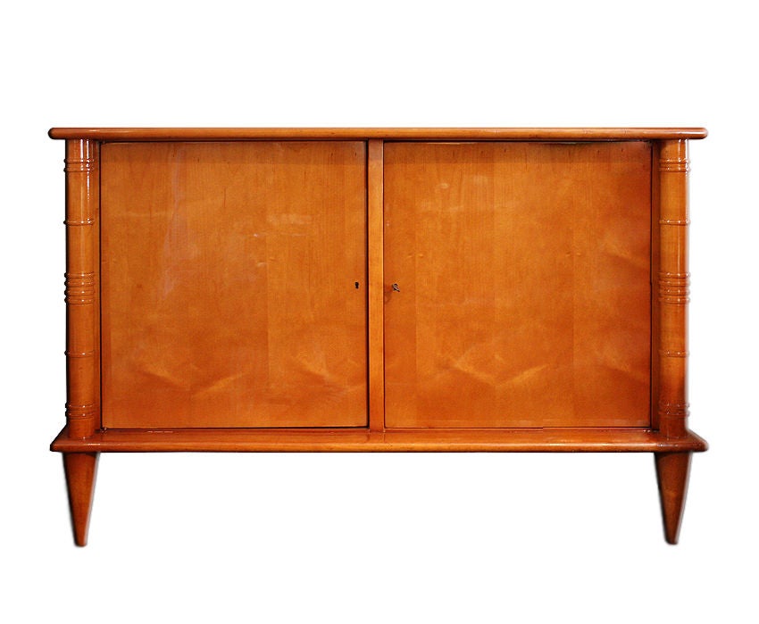 Maurice & Leon JALLOT

Rare Sycamore 1930 Art Deco Commode with 2 doors. 
2 grooved columns on each side and caster socket cone-shaped feet. Refinished and in perfect condition. Cabinet has the original locks and key for the doors. 

This
