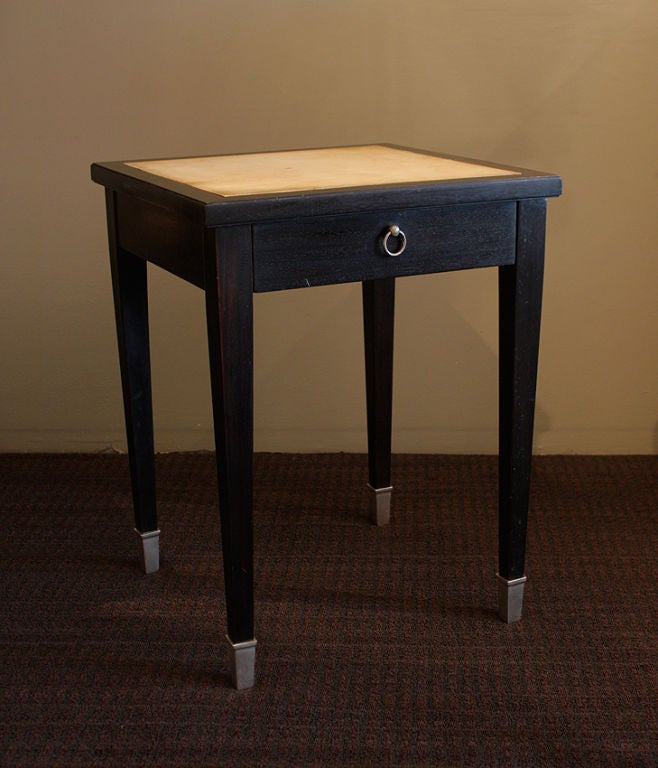 Jacques Adnet (1900 - 1984)<br />
Very rare pair of side tables in lacquered wood, parchment, and silver plated bronze sabots. Each has one drawer with an oxidized brass ring handle. <br />
<br />
Drawer is in beach wood and ash. Structure is in