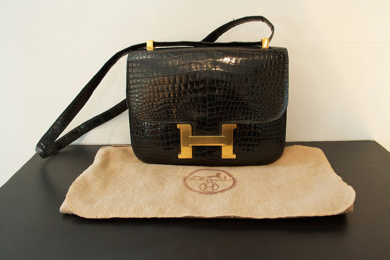 Hermes Constance black alligator bag with gilt metal hardware. 

Stamped Hermes Paris on crocodile material and on hardware. 

France, circa 1975. 

Original dust bag.