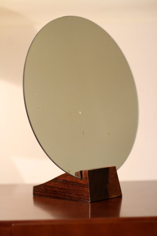 Jacques Emile Ruhlmann & Jules Deroubaix

Extremely rare Art Deco Mirror in Solid brazilian rosewood, circa 1928.
Signed RUHLMANN underneath and stamped DEROUBAIX on the easel.
Jules Deroubaix was one of the most important ébénistes who worked at