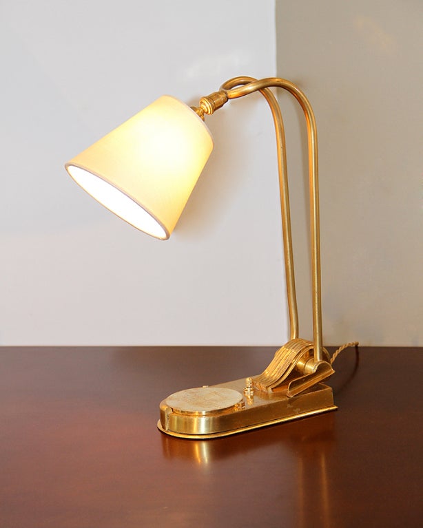 This lamp is from a collection of 26 from the Prince de Galles hotel in Paris, France. The lever on the side lifts up to adjust the angle of the lamp. At the base of the lamp is a bronze plaque monogrammed with the hotel's name, which covers a small