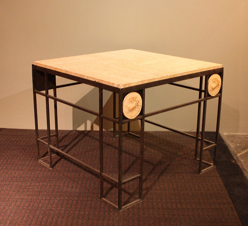 Pair of square wrought iron coffee tables with travertine tops. Comes from a lobby of a hotel in Paris.

The travertine tiles are supported by a wooden under-structure which allows for the four square tile design. 

On each sides of the tables there