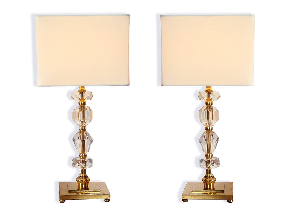 This pair of comes from a set of 24 lamps (12 pairs) from the Prince de Galles Hotel in Paris, France. The lamp bodies are in gilt bronze and the stems are beaded in crystal. These were formerly the table lamps in the hotel rooms.

These are the