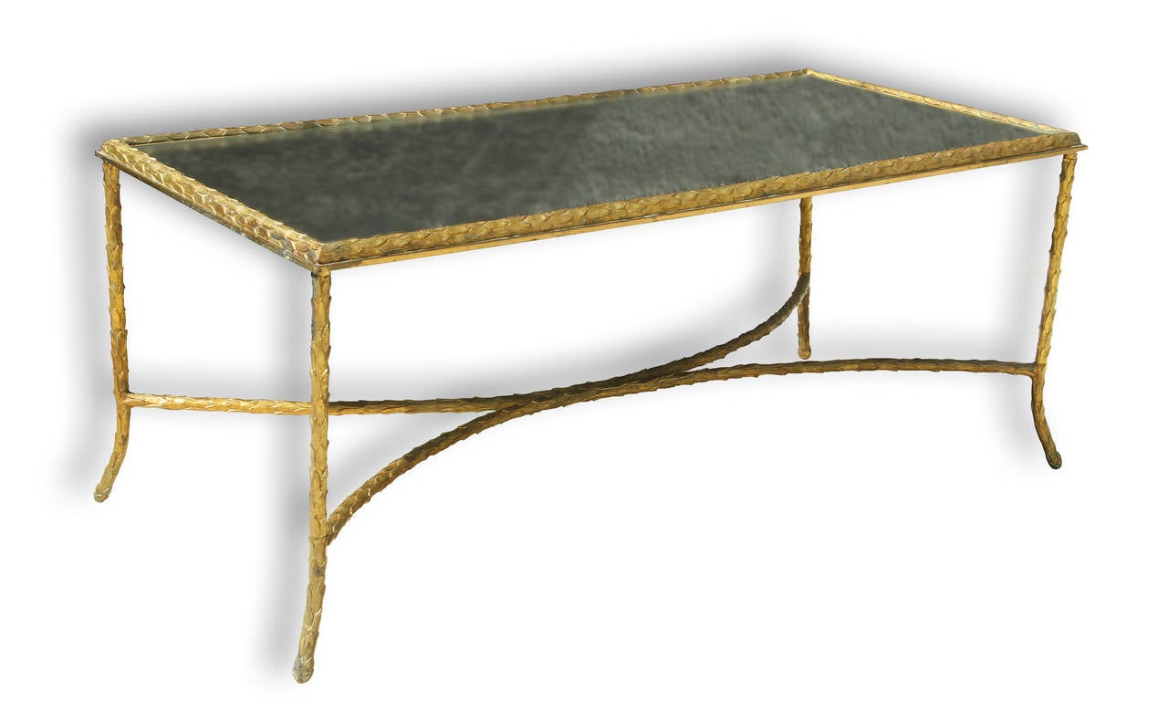 This elegant and extremely rare coffee table by Charles & Fils ( Charles & son ) has a gilt bronze frame and a églomisé glass top. The frame has an exquisite tapered design, and each leg features a slight curving to the floor.
Measurements: