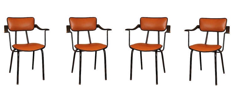 Rare and unique set of 4 arm chairs by Jacques Adnet. 
Fully re-upholstered in new camel and black leather, with pique sellier (saddle stitching).
Base in original condition. France circa 1955-1960. 
Images of chairs in original condition