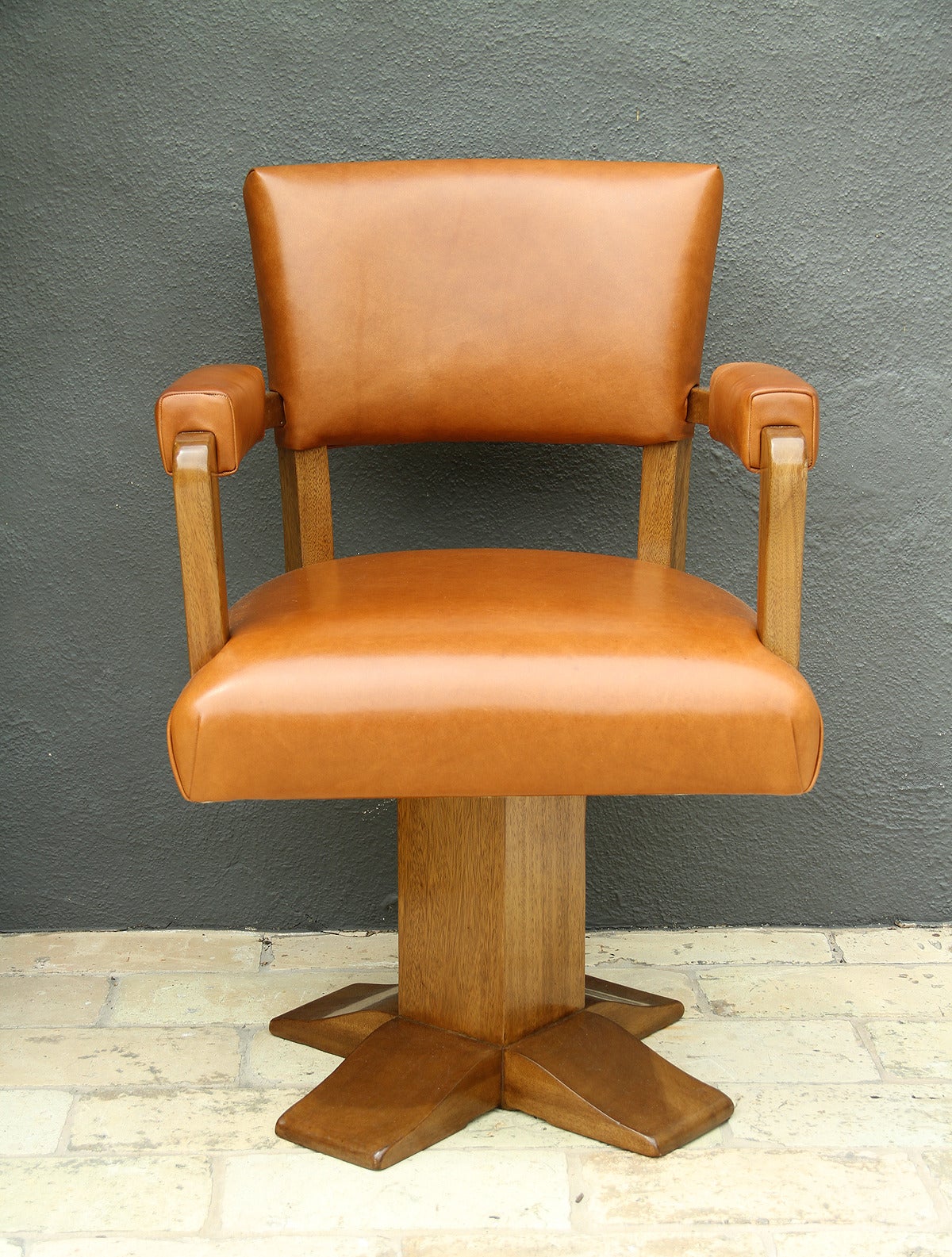 Rare swivel desk chair, France, 1940.
Base in walnut refinished in satin, upholstery in Camel/Cognac leather.
The chair can be swivel but originally the chair had a screw to get the seat static.
The screw has been taken off but can be easily