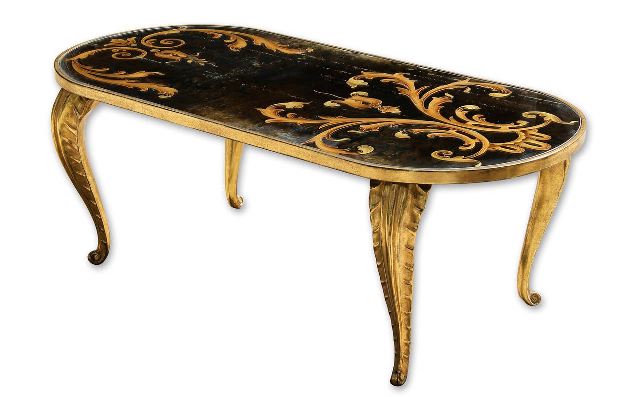 Exceptional 23-karat giltwood oblong coffee table, France, circa 1950.
An authentic 23-karat gold leaf on wood covers this table.
The legs are from the 1950s, the wooden top has been redone posteriorly.
The authentic Art Nouveau mirror comes from