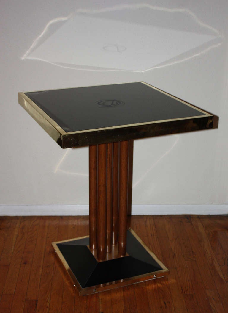 Very beautiful bistro (bistrot) table coming from the French restaurant: Drouant.
This square table is composed of a black glass framed in brass and mounted on a black base, which is also framed in brass.
The top and the base are joined together