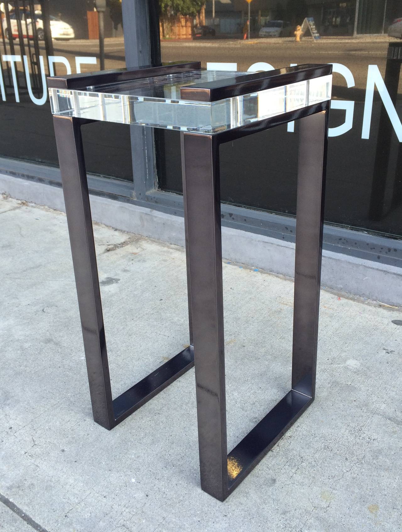 Currently we have three sets ready to ship.
One set in polished nickel, one set in black nickel and one set in polished brass.
Stunning pair of Lucite and black nickel side tables designed and manufactured by Charles Hollis Jones as part of his
