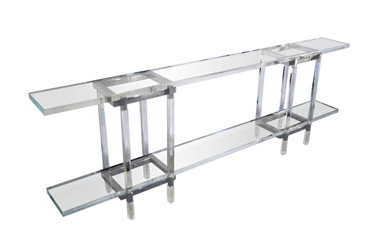 We have one table in brass and one in nickel ready to ship.

1960s design executed in nickel and Lucite long and narrow console table designed and manufactured by Charles Hollis Jones in Los Angeles, California.
The table is part of is 