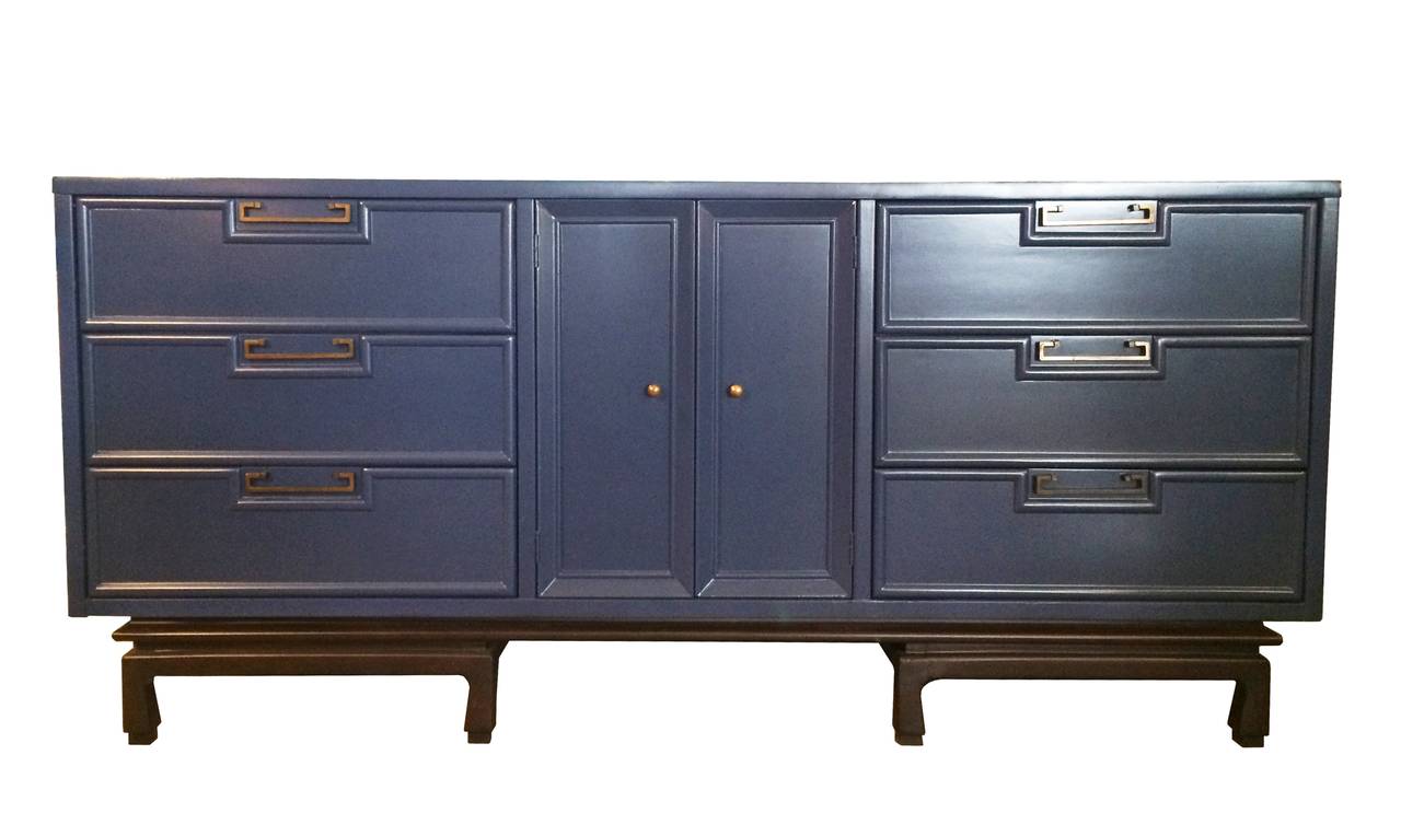 Stunning dresser by American of Martinsville finished in a teal lacquered finish with a dark walnut base, the handles are made of solid brass.
The dresser has three 9 drawers, 6 out and 3 concealed.
The dresser is solidly built and with great
