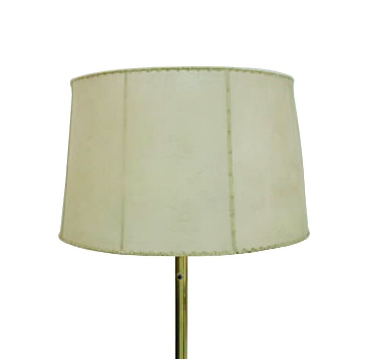 Beautiful 1950s brass floor lamp with round base and two bulb receptacles. The lamp is finished appropriately with a vintage goatskin shade that will lavish any room in warm, rich light.

The lamp is fully functional with all original wiring and