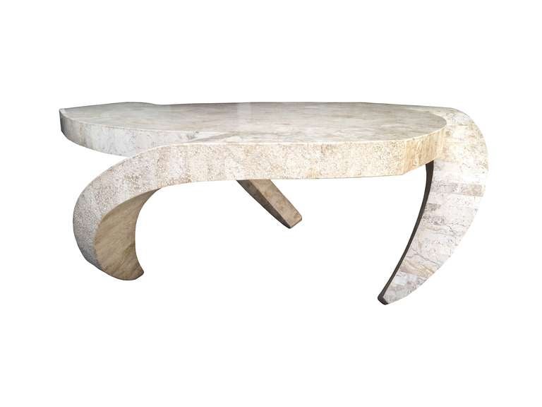 Architectural coffee table designed by Maitland Smith and made in the Philippines.
The table has beautiful lines, it looks kind of futuristic and like is about to take off, the tessellated stone has a wonderful color to it and the legs have a very