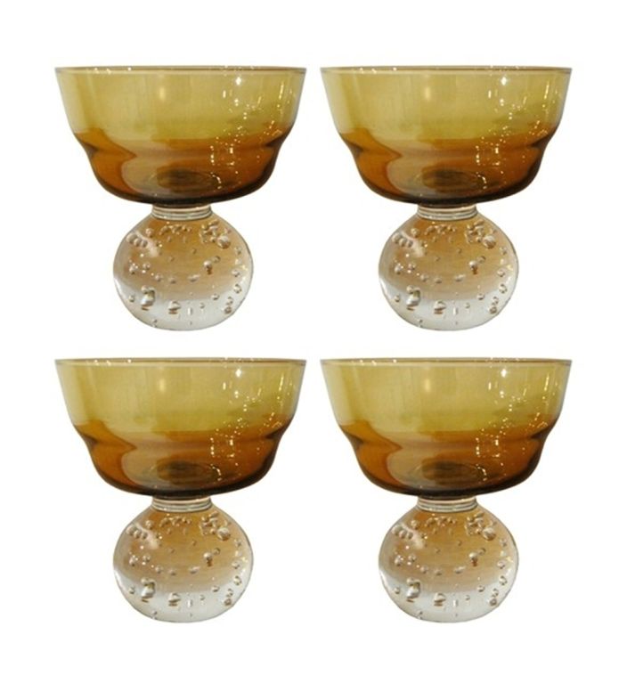 A shimmering of American mid-century amber colored art glass vases with clear spheroid bases by  
