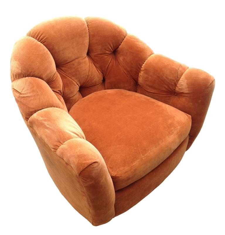 Beautiful swivel chair upholstered in an orange velvet fabric with tufted back.
The chair is very comfortable, It sits on a 5 star swivel base and swivel 360 degrees.  The fabric is quite worn and will need to be reupholstered.

If you are coming