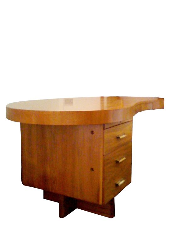 Gilbert Rohde kidney shaped solid wood desk. the desk has been refinished and is in mint condition.<br />
The desk has three drawers and a writing shelf, the desk is very uniquely designed with very architectural lines, some of these desks were