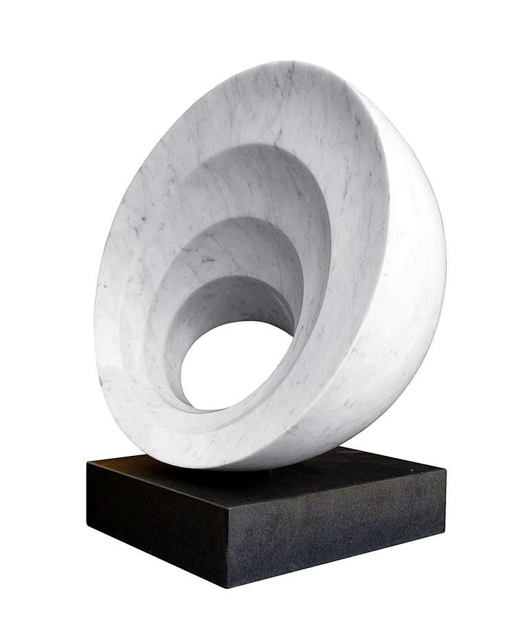 Stunning Carrara marble sculpture sitting in a black granite base.
The graduated circles add a great architectural look and the contrast of the black granite and the white speckled carrara marble flows beautifully.

The piece is signed A.