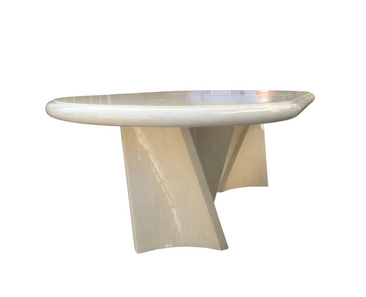 A stunning dining table made of bone tiles with a heavy lacquer. The sculptural form is very elegant as well as the bull nose edge.
The architectural lines of the pedestals are truly stunning and give the table a very modern and chic