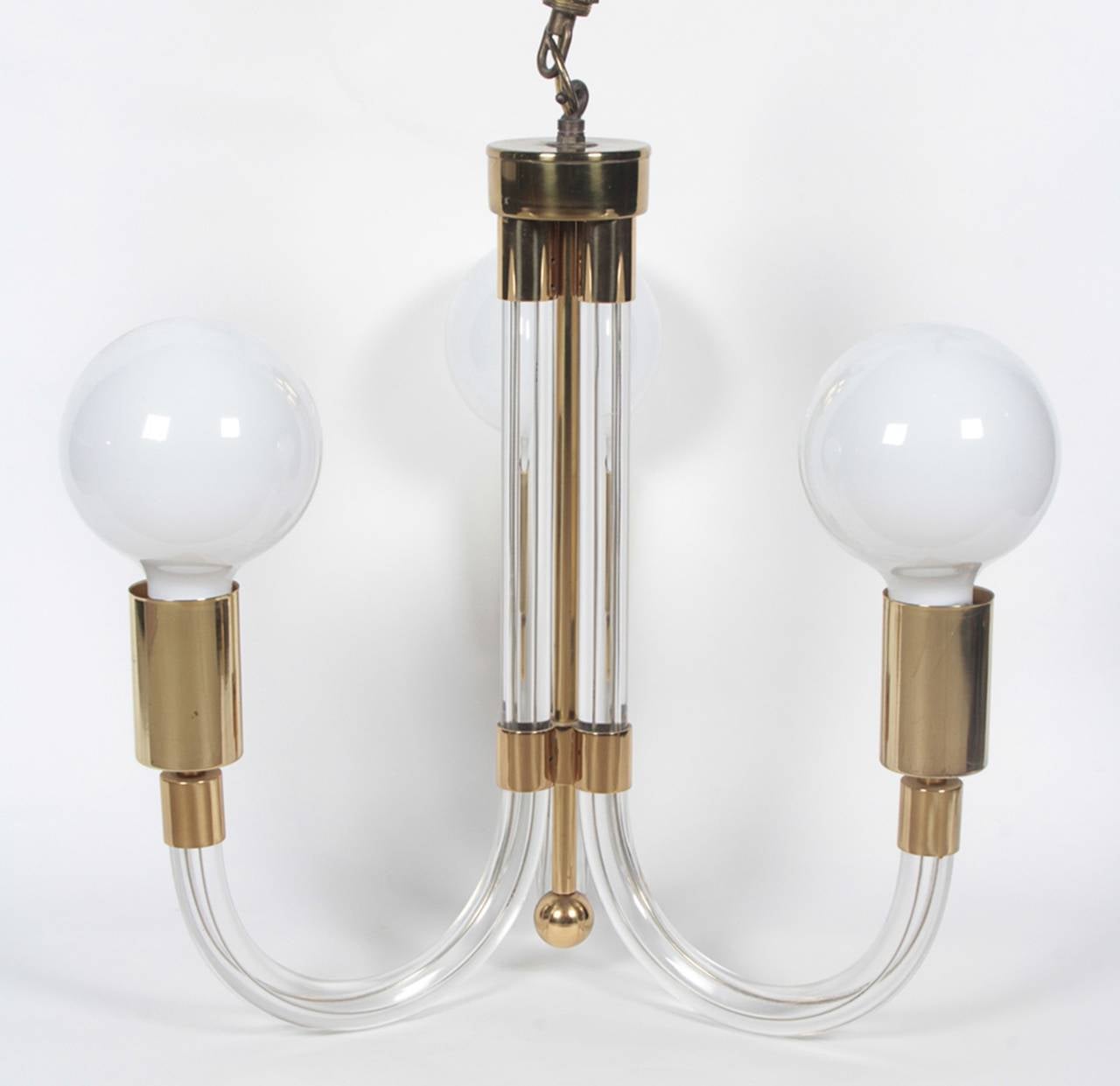 Fantastic Lucite and brass chandelier designed by Charles Hollis Jones in the 1960s.
The way the chandelier is made is very ingenious, the individual Lucite arms are casted Lucite embedding the electrical wire in the Lucite which gives you a