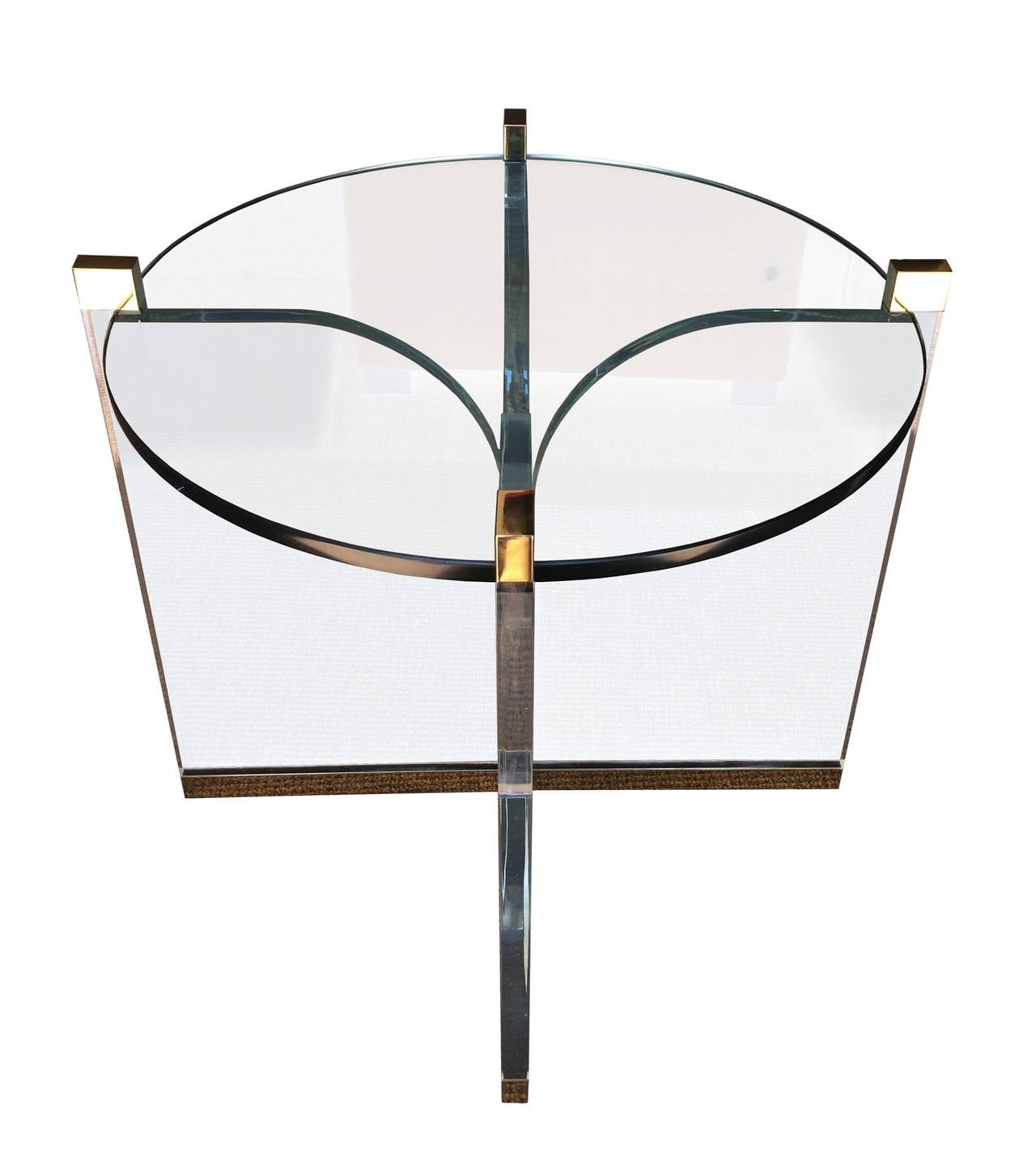 Stunning center table in Lucite and brass designed and manufactured my Charles Hollis Jones in the mid-1970s. The table is very delicate to the eye and yet very imposing in design appeal, they combination of metal is perfect and the execution out of