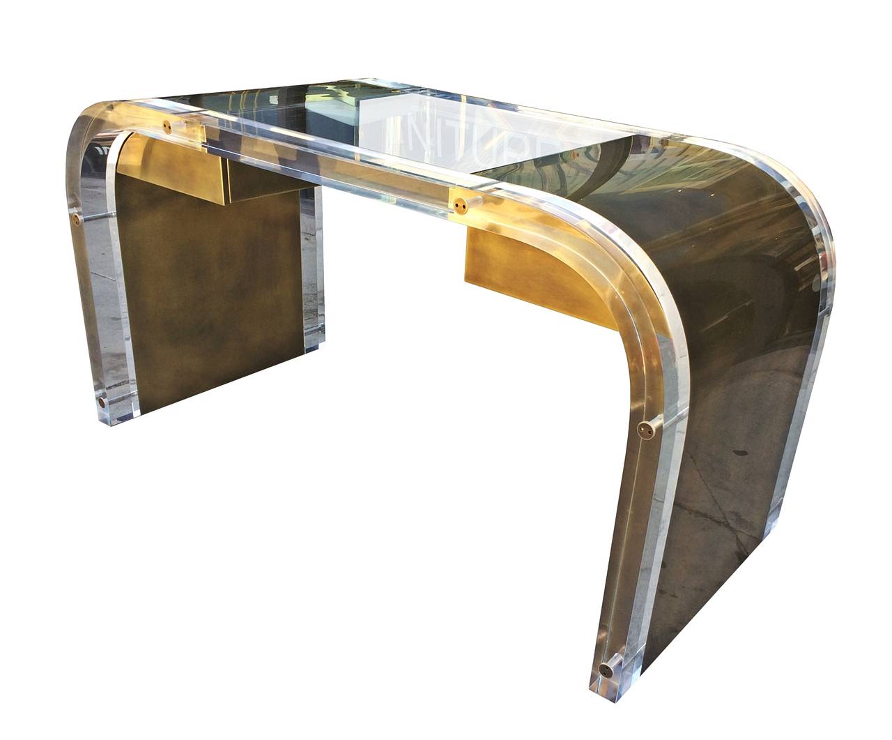 This desk is in stock and ready to ship.

Signed, dated and numbered 2/11.

Beautiful desk in Lucite and solid brass with a bronze finish designed and manufactured by Charles Hollis Jones from his 