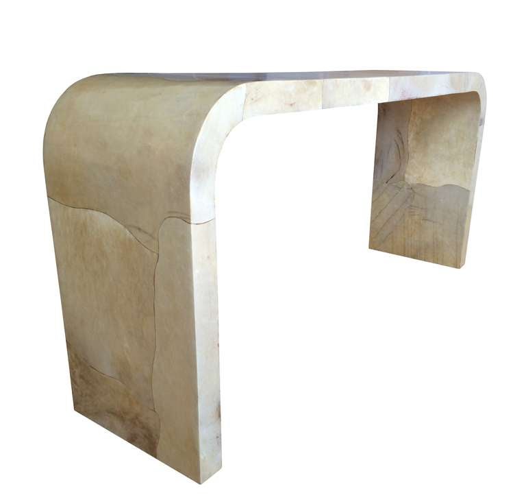 Beautiful goatskin parchment waterfall style console table made in Colombia in the 1960s possibly by Enrique Garcez. The table is well built, the placement and cuts of the goatskin show great attention to detail and execution. The table is original