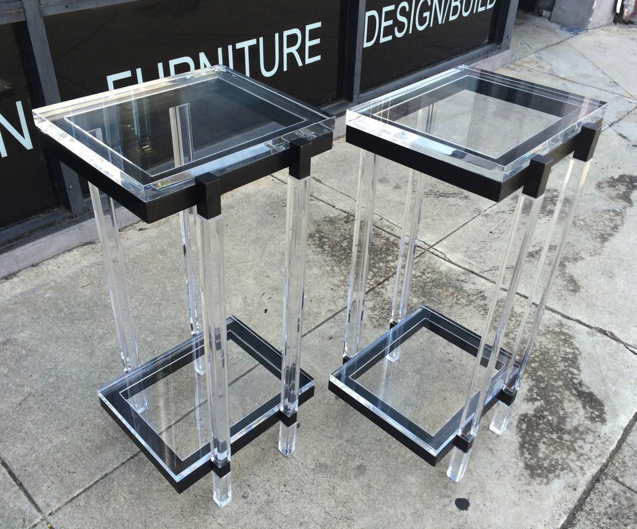 Beautiful set of tall side tables or pedestals in Lucite and black enamel metal by Charles Hollis Jones.

The tables are part of the 