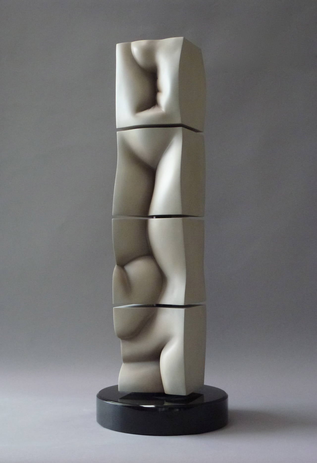 This freestanding work belongs to Ragir's abstract body of work which explores figure as landscape. The painted cast resin column is composed of four independent cubes anchored by a central pole and marble base. The cubes can be aligned or rotated