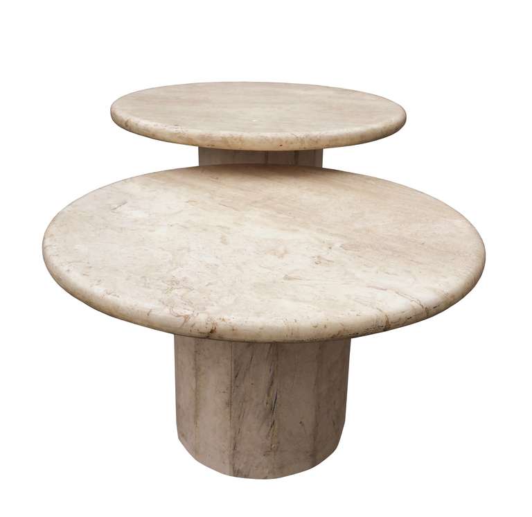 Beautiful pair of travertine nesting table with round tops and architectural bases. The tables are in excellent original condition and ready to ship.
Measurements:
Taller table: 16.5