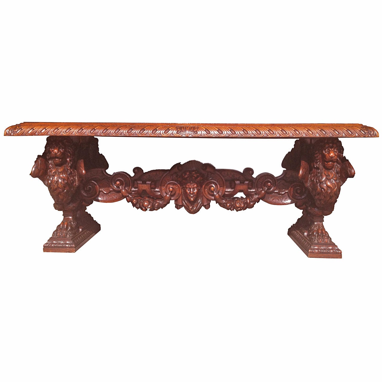 Ornately hand-carved wooden table by world famous Venetian sculptor Valentino Panciera Besarel (1829–1902). Solid wood table with cupid carving in center and Italian style Venetian lions head carvings throughout. Beautiful dark colored wood. 
The