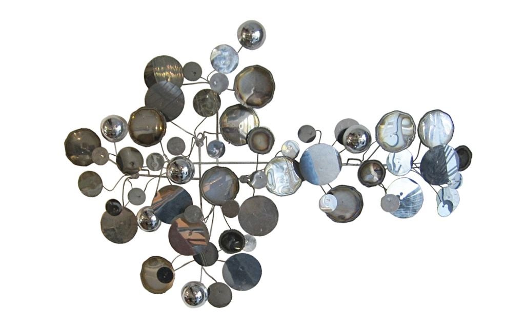 Raindrops, a wall sculpture of punched and torch cut polished chrome discs and domes by Curtis Jere.<br />
The piece is in excellent condition, it can be hung in different ways for different views.<br />
About Curtis Jere<br />
<br />
Curtis