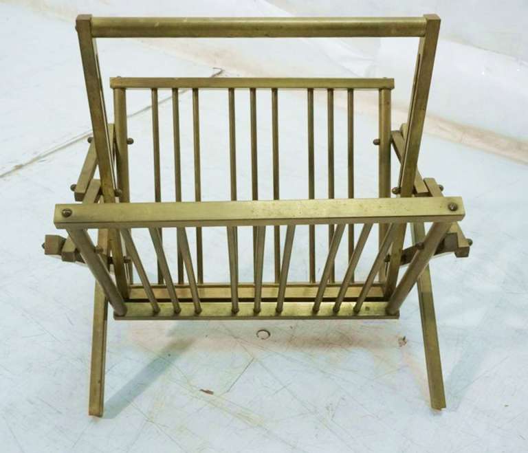 Beautiful magazine rack in solid brass in the style of Mastercraft, the piece is in excellent condition, the brass shows a nice aged patina and we can have it polished upon buyers request. The piece is very well designed and executed, the piece is