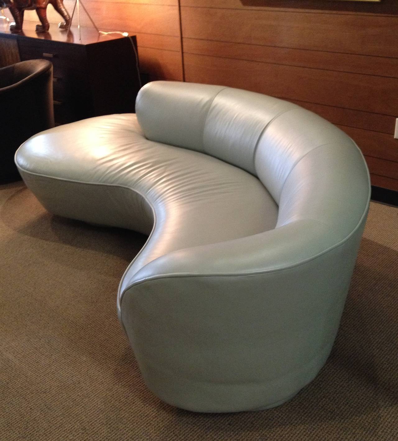 Stunning serpentine sofa designed by Vladimir Kagan and manufactured by Directional Inc.
The sofa and ottoman are upholstered in beautiful sage Eldeman leather and it is very smooth and comfortable.

The sofa is in excellent condition and can be
