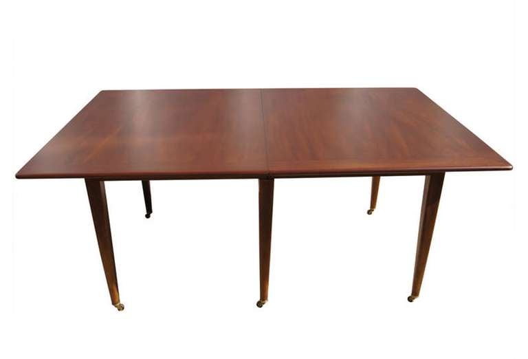 Incredible mahogany extension dining table by Edward Wormley for Dunbar, newly refinished and in excellent condition.
This beautiful table has very architectural lines, made of solid wood and mounted in casters, the table is in excellent condition