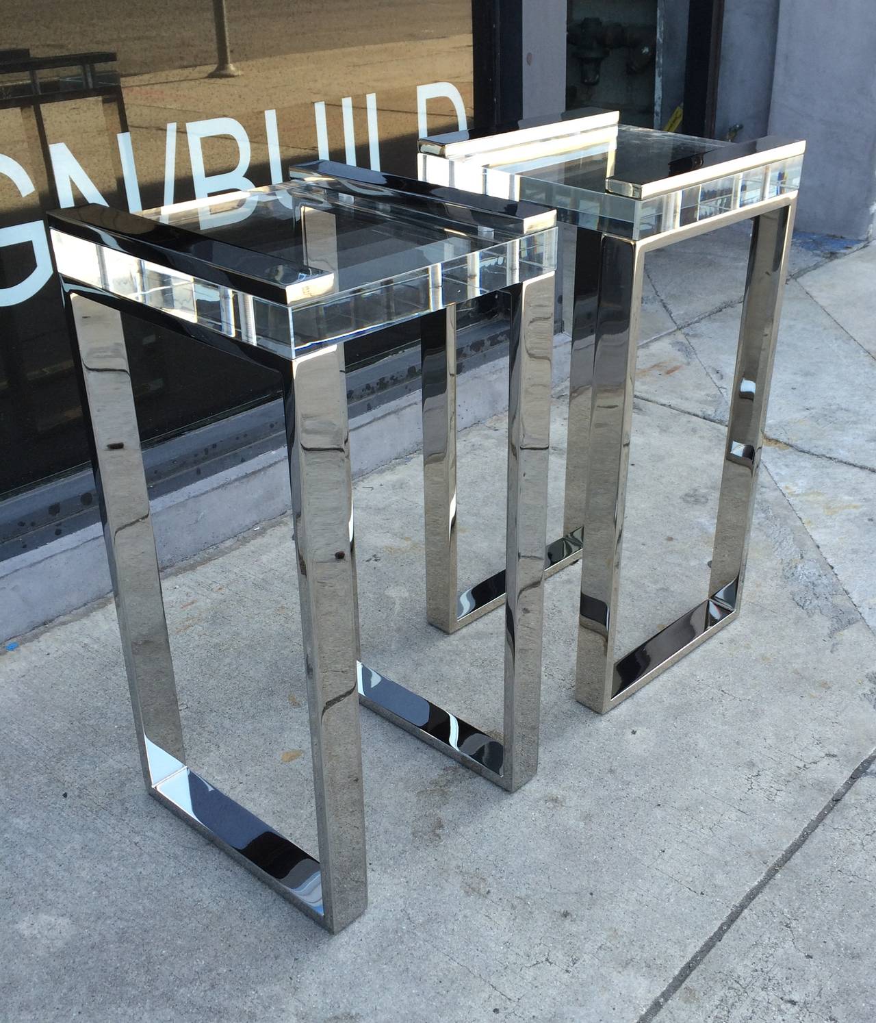 Stunning pair of Lucite and nickel side tables designed and manufactured by Charles Hollis Jones as part of his 