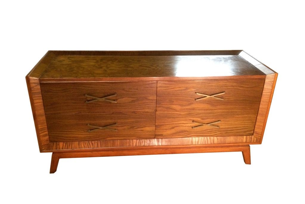 Fantastic four-drawer dresser by Paul Frankl with his signature X-brass pulls.
This beautiful dresser is very well made, the drawers are very deep and they can accommodate lots of clothes, the dresser has wonderful lines, the brass pulls have