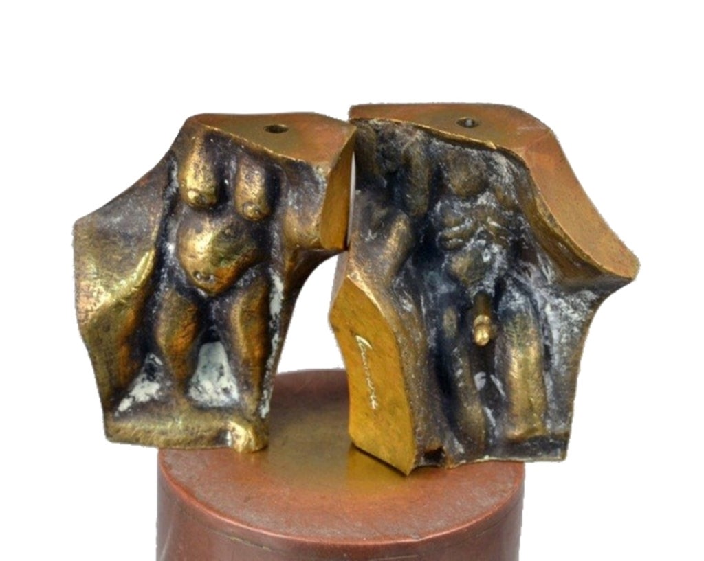 Two interlocking bronze pieces, each 1 3/4 inches (H). Inscribed Domenico Calabrone on side, 