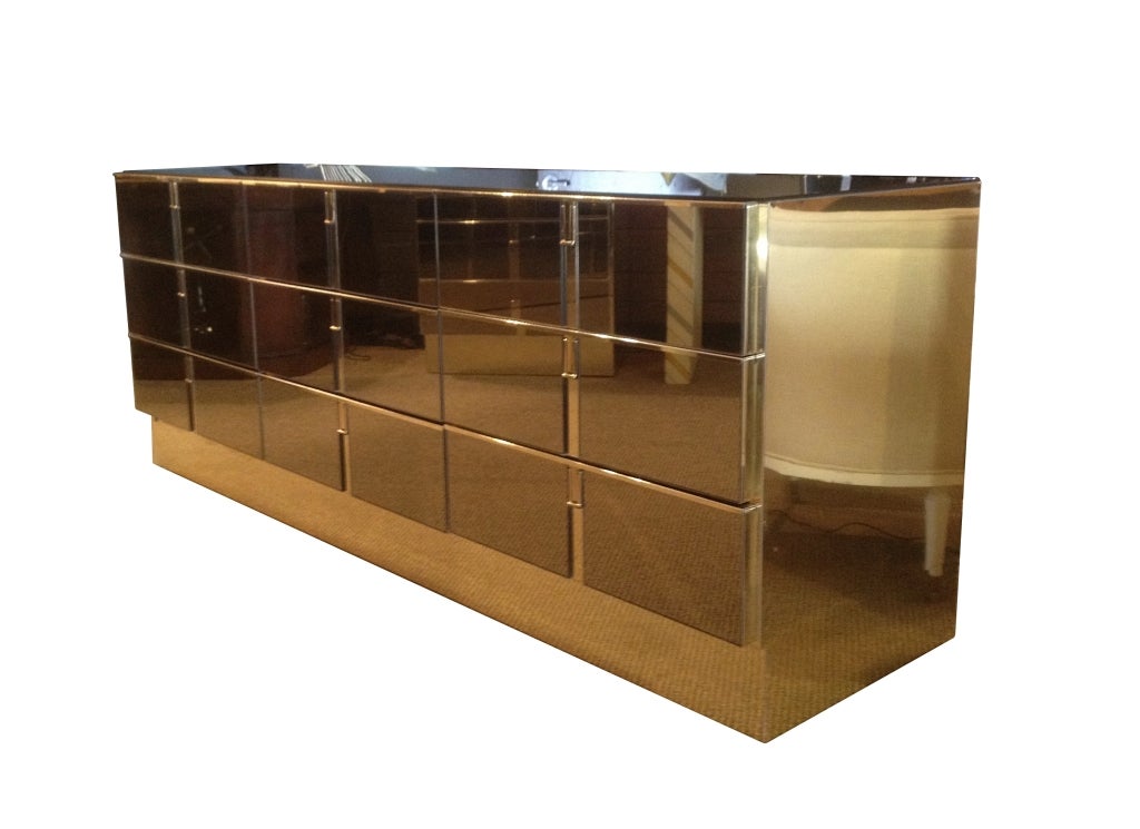Amazingly stunning 9 drawer dresser embossed in brass and bronze mirror by Mastercraft.
The cabinet is very well made, the combination of materials used compliment each other very well, the pulls are also very cool, they just hang down and pivot