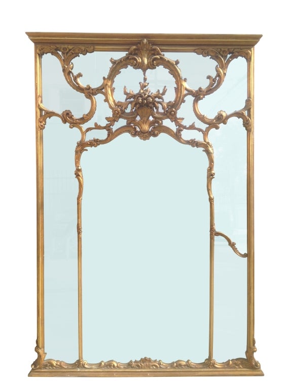 Stunning European wall mirror with beautiful hand-carved and gold gilded frame.
The mirror is large in size and is perfect for a very tall foyer/entryway, the gold gilded finish on the frame is in very good condition and the frame is sturdy and