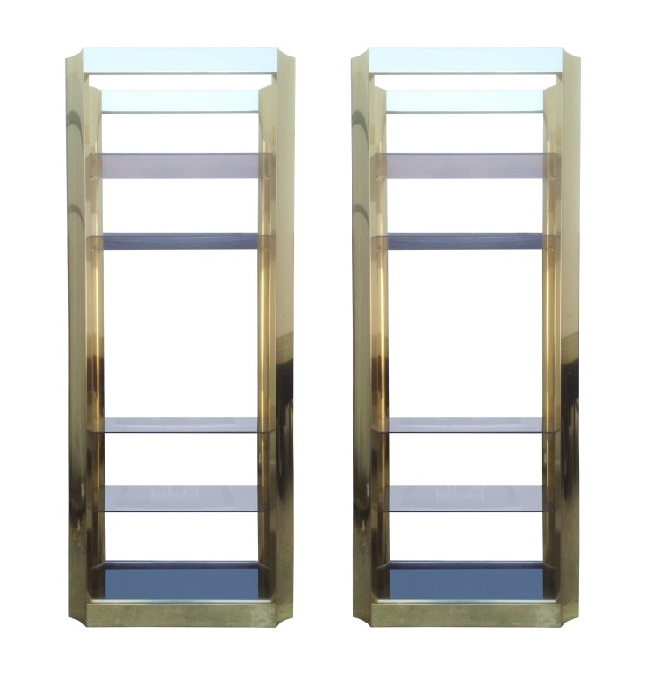 Beautiful pair of 6' tall brass display cabinets in possibly Mastercraft but they are not labeled.

Each cabinet has five smoked glass shelves which are not adjustable, the pieces I believe are made of aluminum coated in brass so the frames are