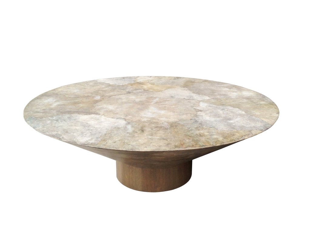 Beautiful parchment coffee table in a conical shape sitting on a round walnut base.
The table is beautiful with great architectural lines, the parchment shows a mix of different gray and brown colors that blend beautifully.
The table is in