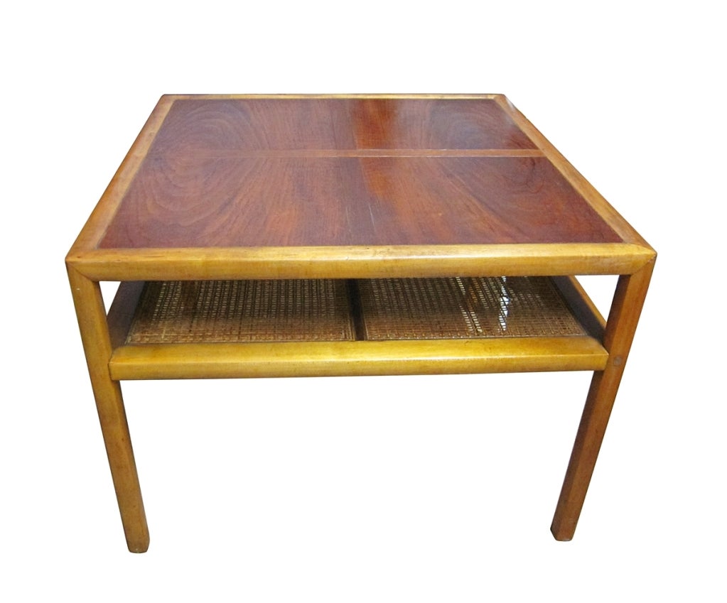 A generous cocktail table with fine woven cane shelf. One of a number of designs that comprises the New World Group, designed by Michael Taylor. Produced by Baker Furniture (labeled). American, circa 1950.

The table is in good condition and can