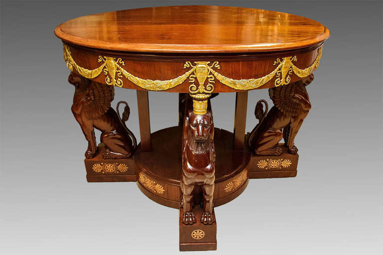 A very large and fine quality  French Empire style  carved  parcel-gilt mahogany center table.
The top supported by four imposing hand carved seated Lions.

Stock number: F99.