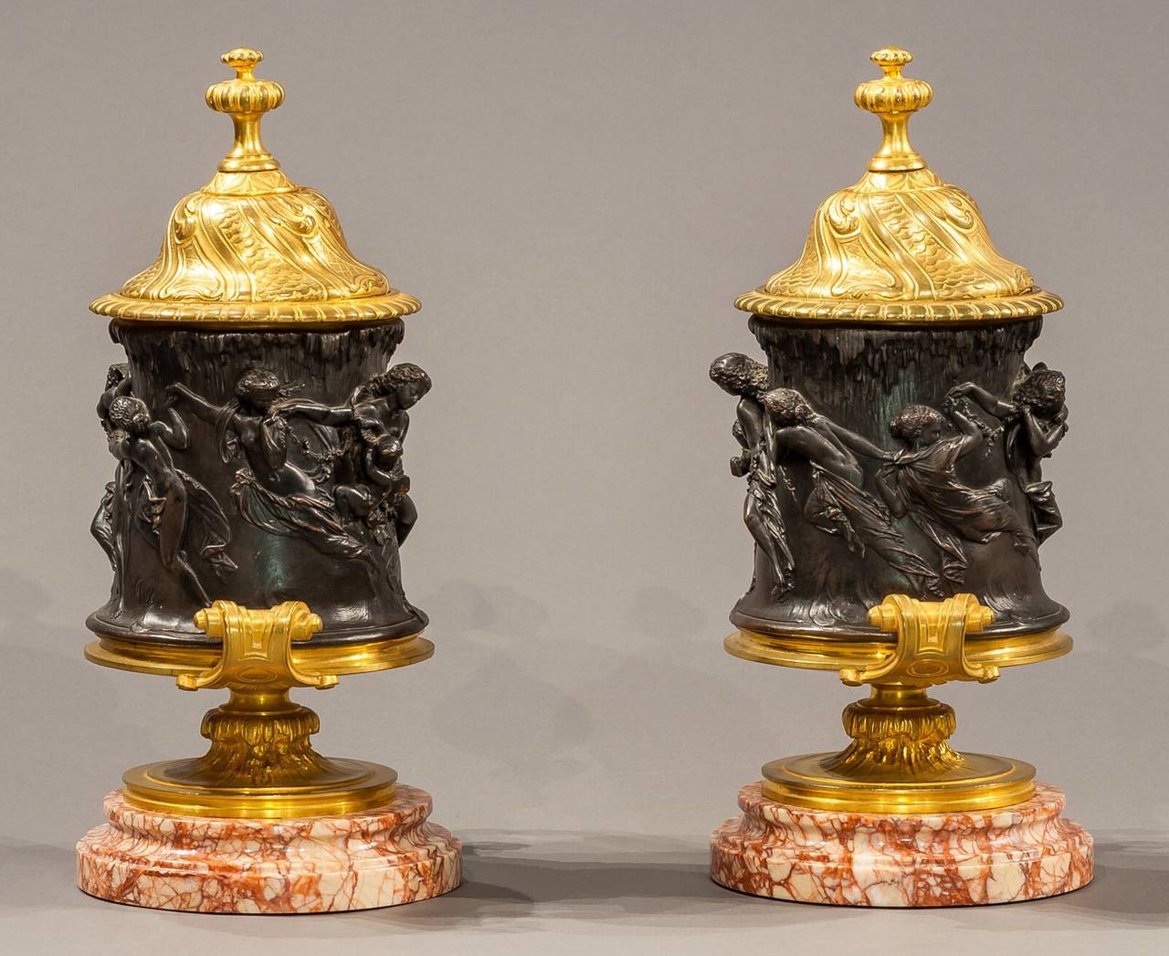 19th Century Signed Pair of Patinated and Gilt Bronze Figural Covered Urns
